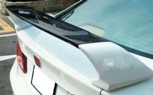 SPOILER. The primary purpose of a spoiler is to reduce drag. This is the aerodynamic device that goes well on a street car.