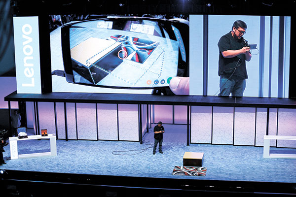 VIRTUAL DEMO. Johnny Lee, engineering director of Google Tango, demonstrates the measuring and room sensing features of the Phab2 Pro phone during the keynote address at the Lenovo Tech World event last June 9.