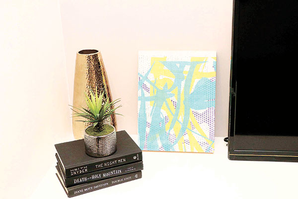 A Charles Lahti artwork displayed alongside accent pieces